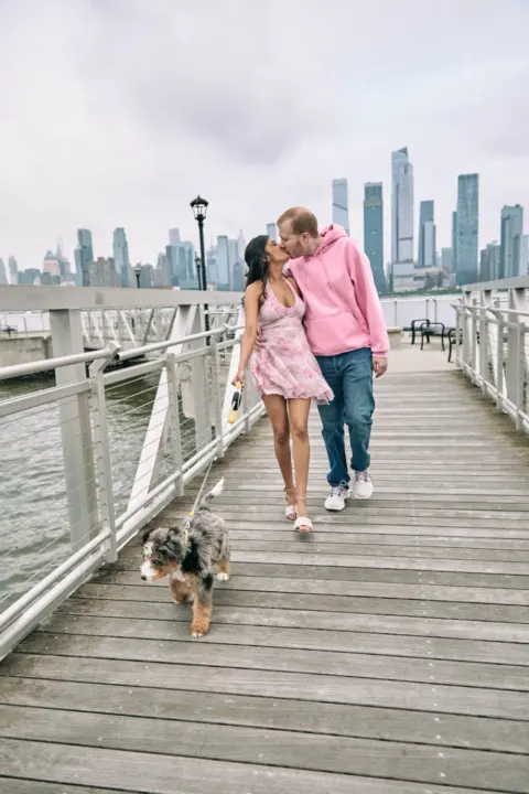 Couple doing a family photo shoot with their cute Bernedoodle