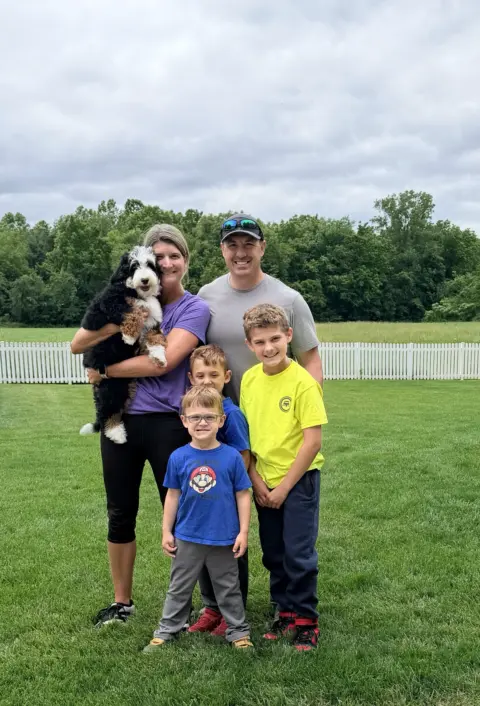 A young family, very excited to take their new bundle puppy home.