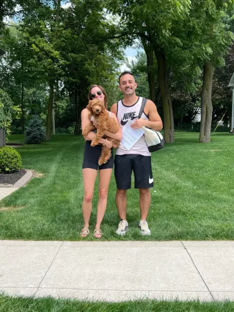 Happy family picking up their first family addition