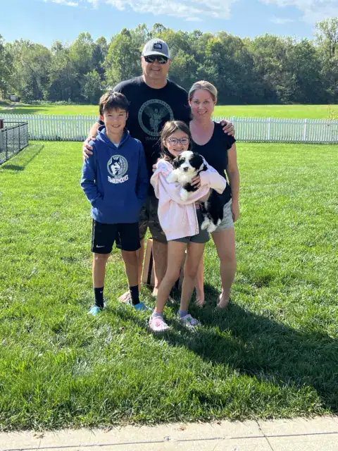Family taking home their new Bernedoodle family member