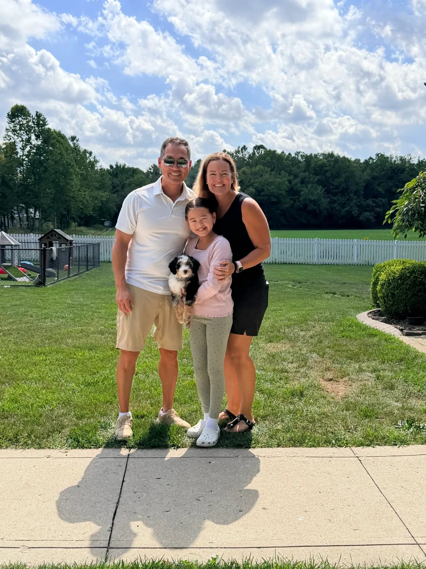 A family of three adopting a puppy to make it four.