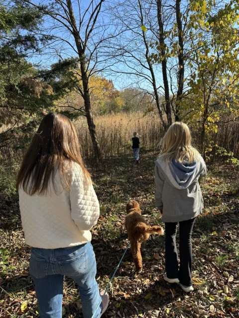 Family on a walk with their Goldendoodle