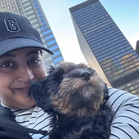 Gaargi Kulkarni with her Bernedoodle by Chicago skyscrapers