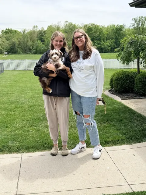 Mom and daughter taking home their new best friend