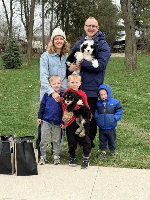 A young family after welcoming another Bernedoodle